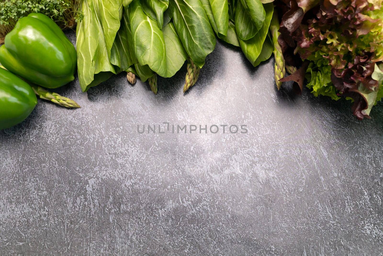 Flat Lay Assortment Of Fresh Organic Home Grown Green Vegetables On Gray Granite Table. Asparagus Plant, Bell Pepper, Bok Choy, Red Leaf Lettuce, Bittercresses. Healthy bio food.Horizontal,copy space