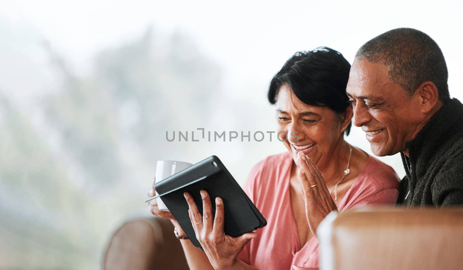 Relax, wave and video call with old couple and tablet on sofa for communication, social media or networking. Technology, contact and mockup with senior man and woman in living room at home for search by YuriArcurs