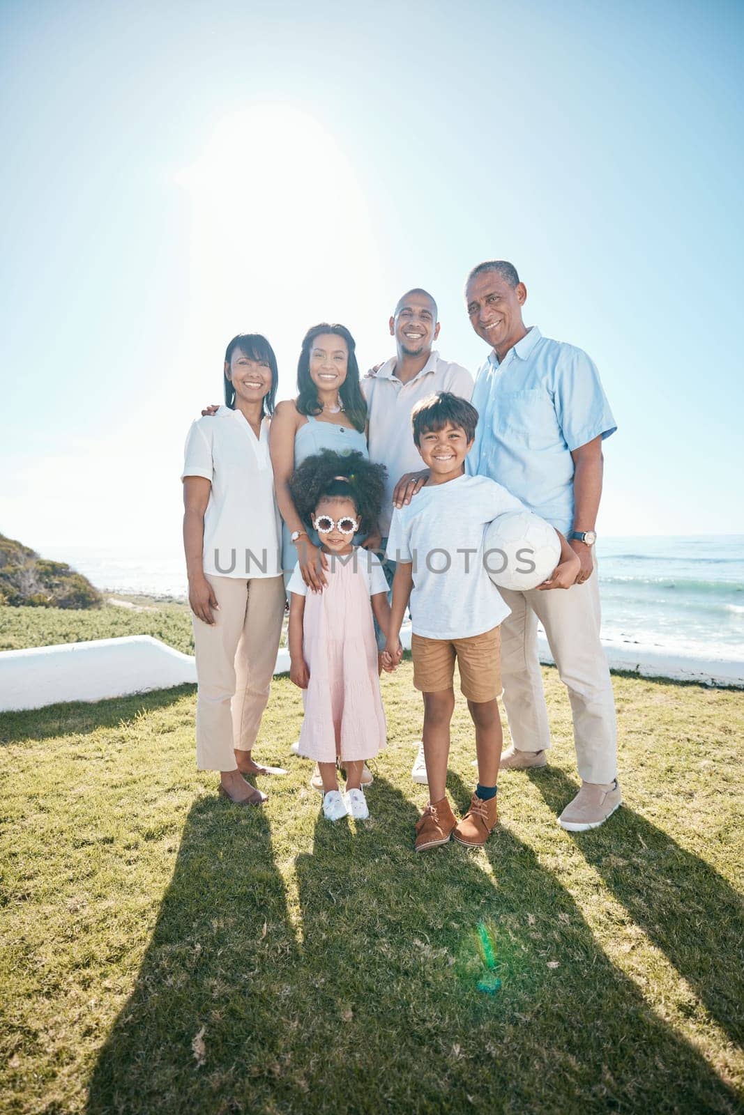 Smile, big family and portrait at ocean on vacation, holiday or summer travel mockup space. Beach, happy grandparents and children, mother and father bonding together with football at sea outdoor