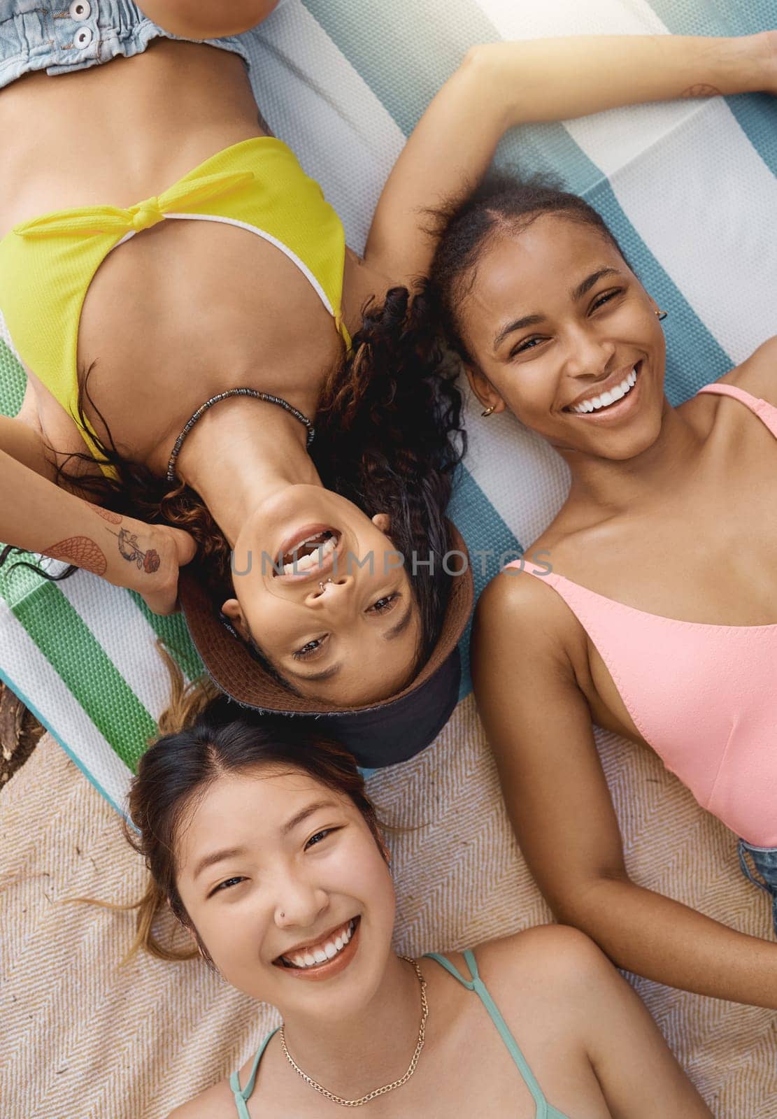 Friends, portrait and happiness, sunbathing with top view, adventure and diversity, female people have fun together outdoor. Lying down, sun and travel, young women with smile and freedom in summer.