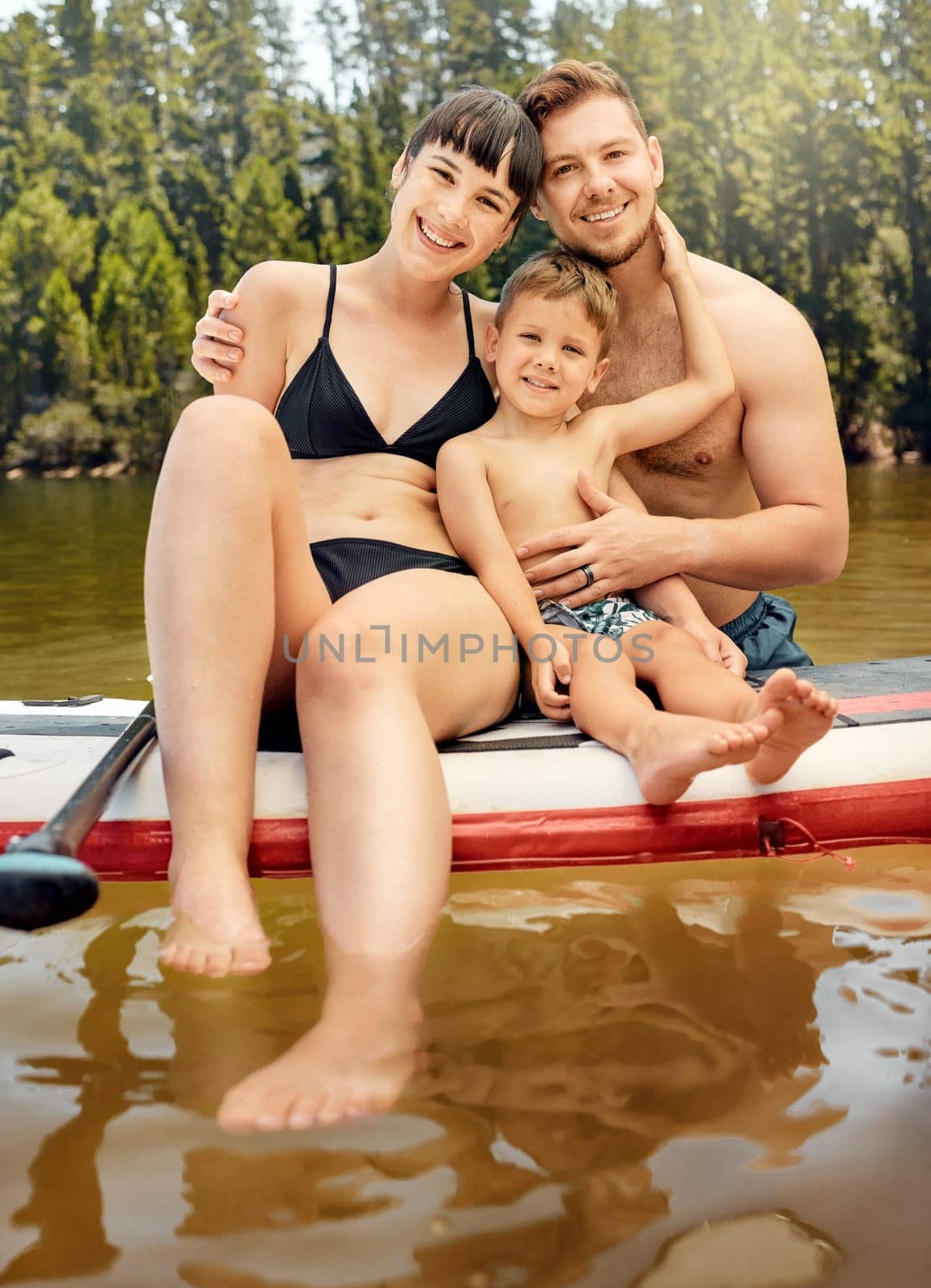 Lake, family on paddle board and relax outdoor, summer holiday and travel in portrait. Adventure, freedom and fun, man and woman with boy child in swimsuit, vacation and bonding together in nature by YuriArcurs