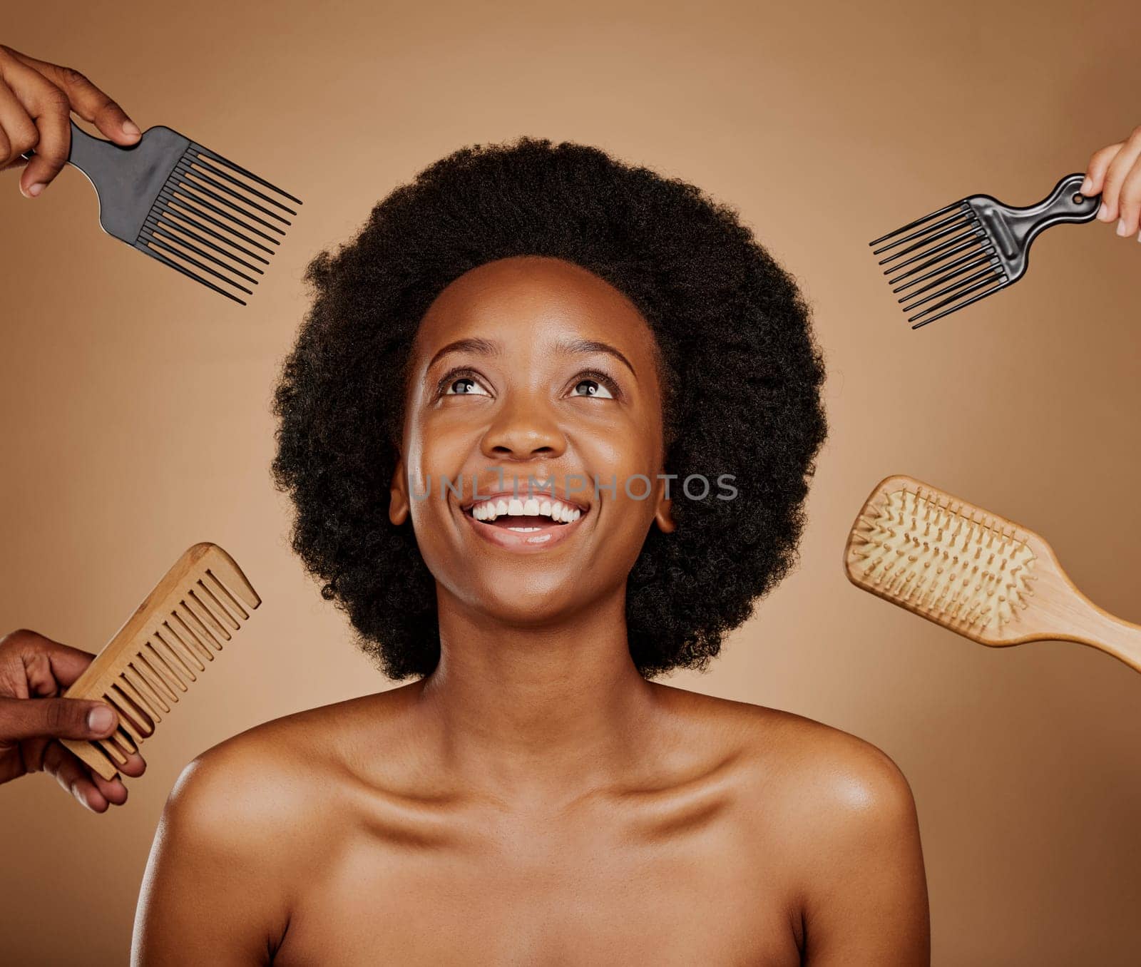 Hair, comb and brush selection with a black woman in studio on a brown background for beauty or cosmetics. Salon, afro or haircare with hands at a hairdresser and an attractive young female model.