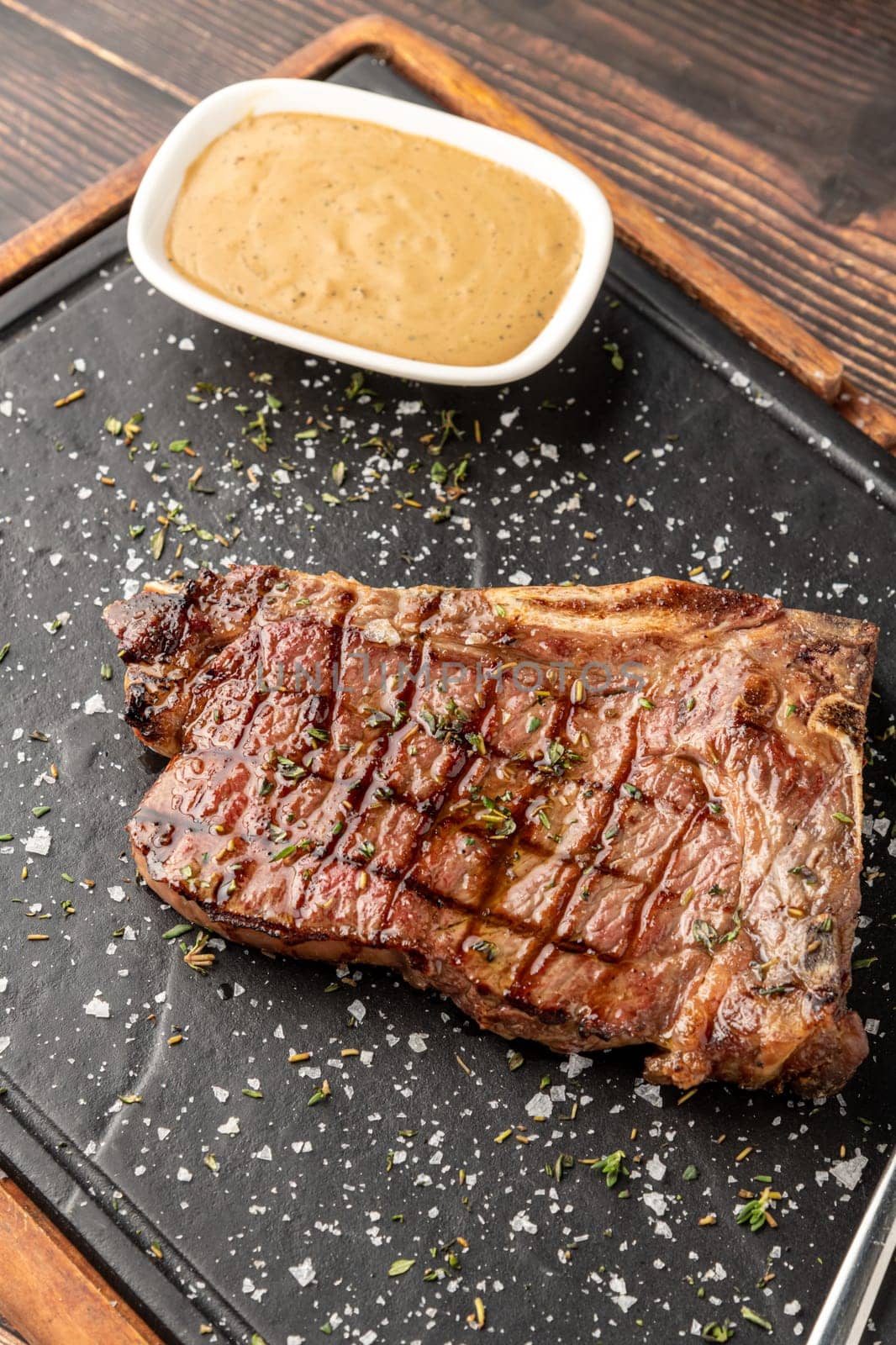 New York Strip Loin on stone cutting board at steak house by Sonat