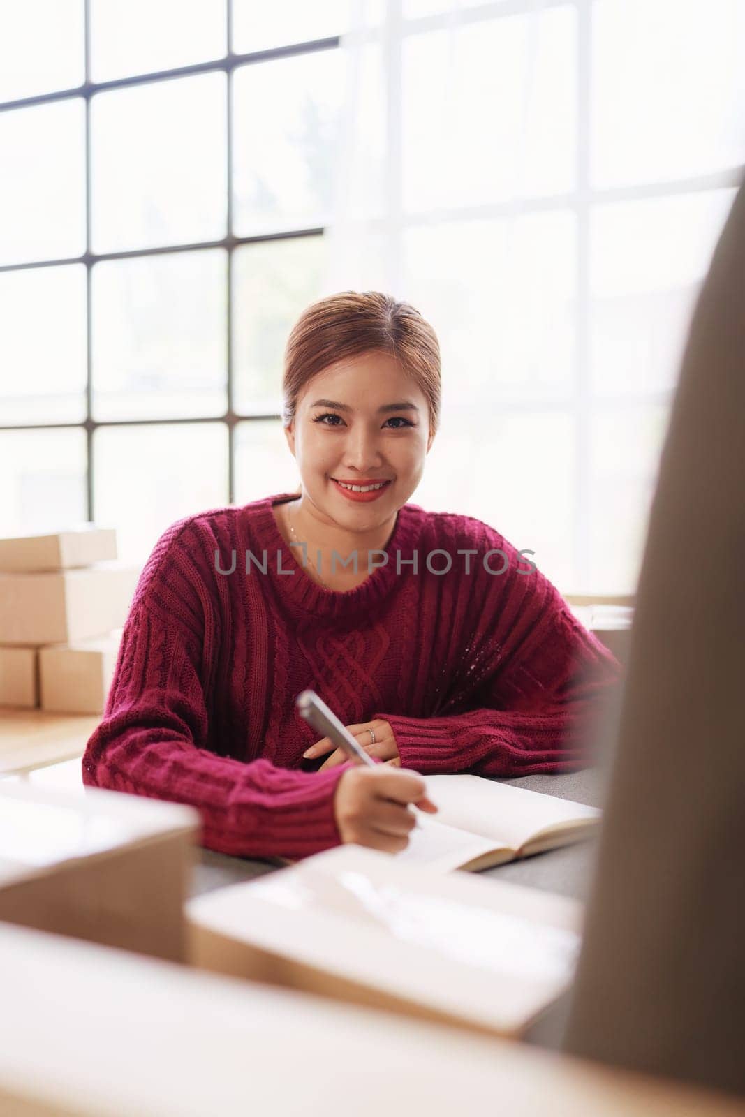 Businesswoman with Laptop and Parcel Box. A Symbol of SME Success in E-Commerce