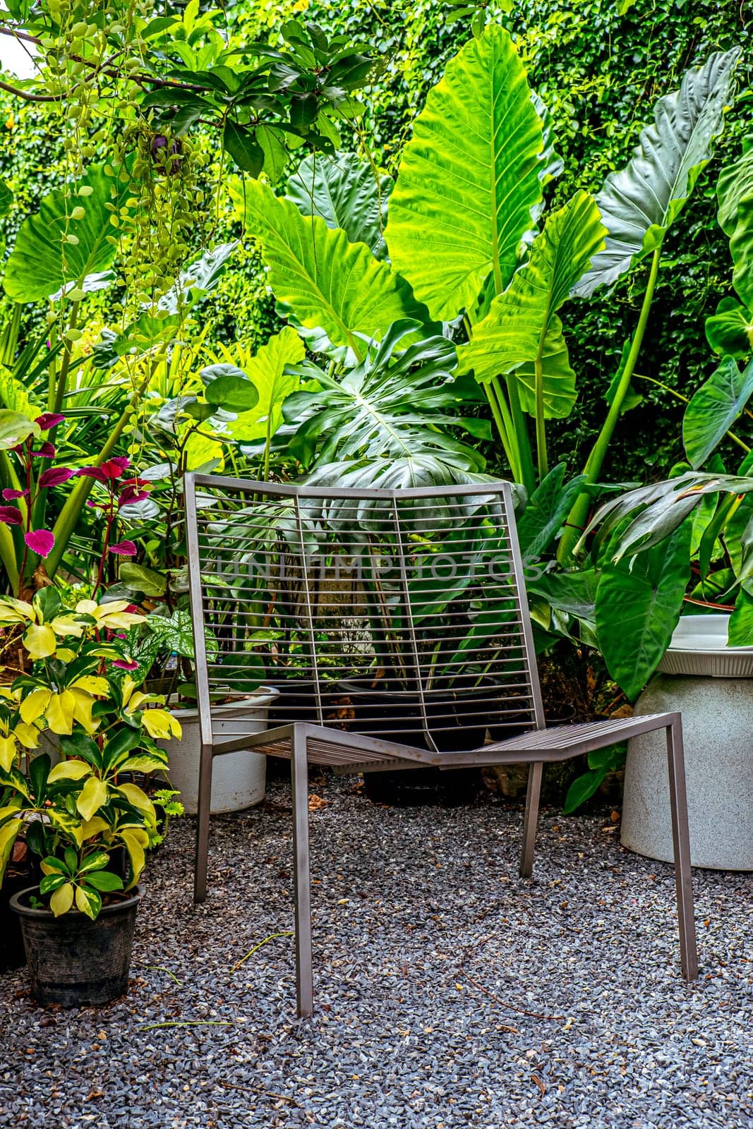 A relax corner in the garden park with steel bench by Petrichor