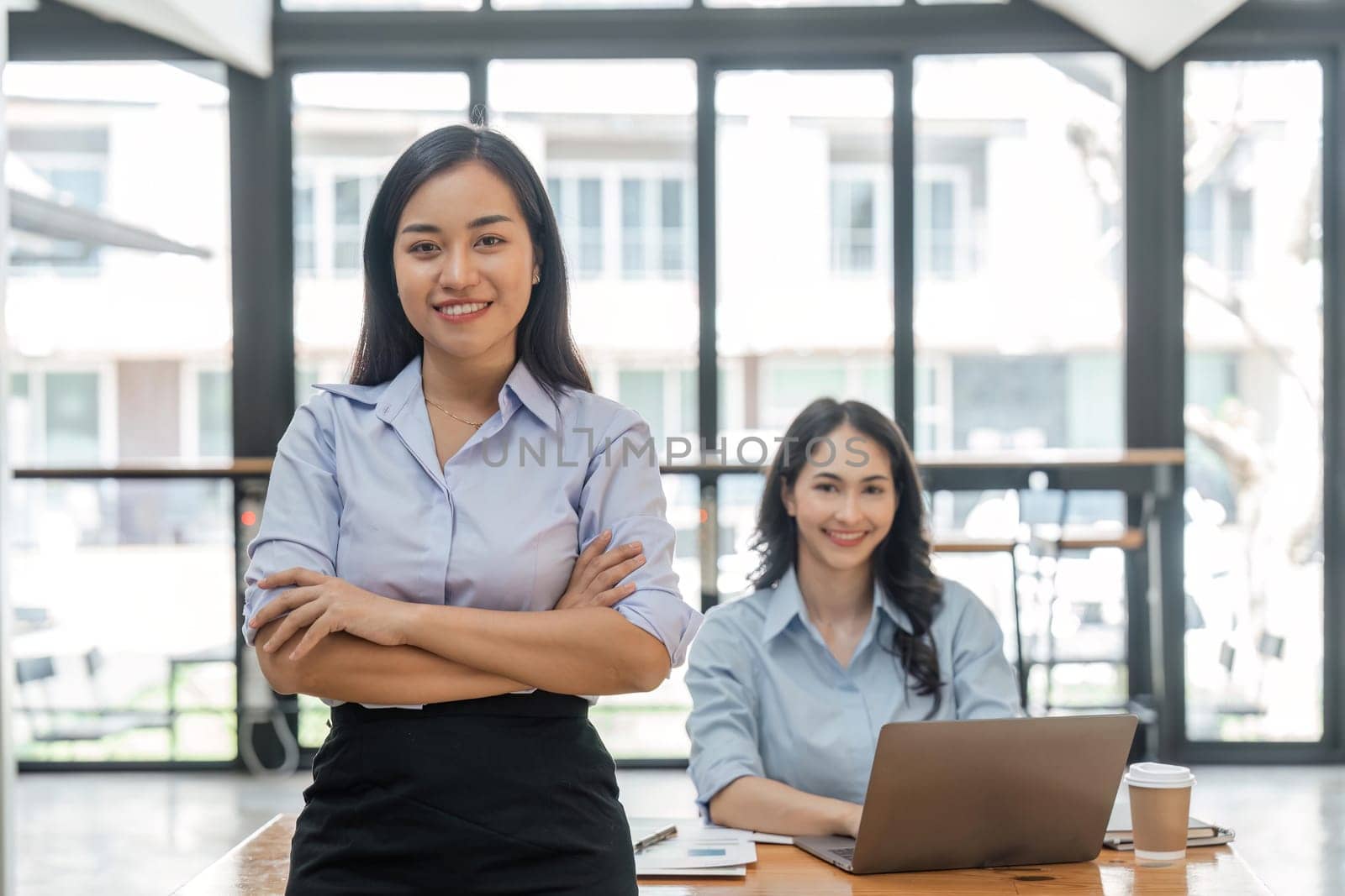 Young asian business woman entrepreneur looking at camera in the office.