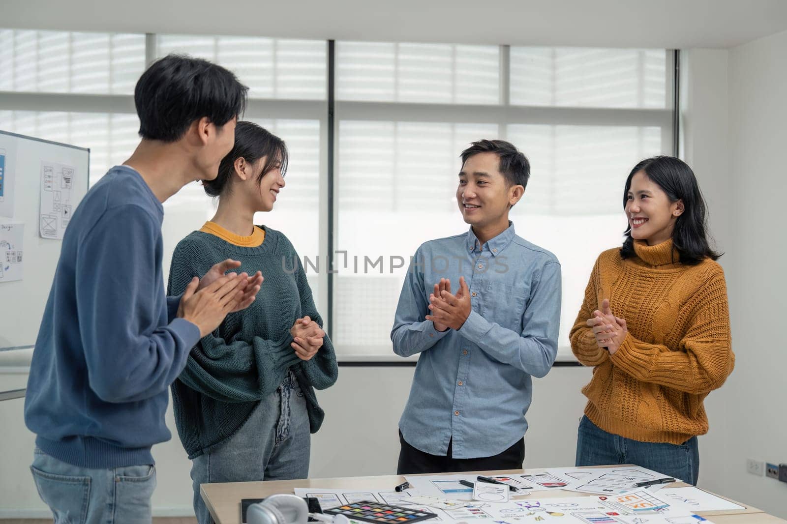 Successful Web developer team. Group of young modern people in casual wear using modern technologies while working web developer Clap your hands to congratulate the success in the creative office.