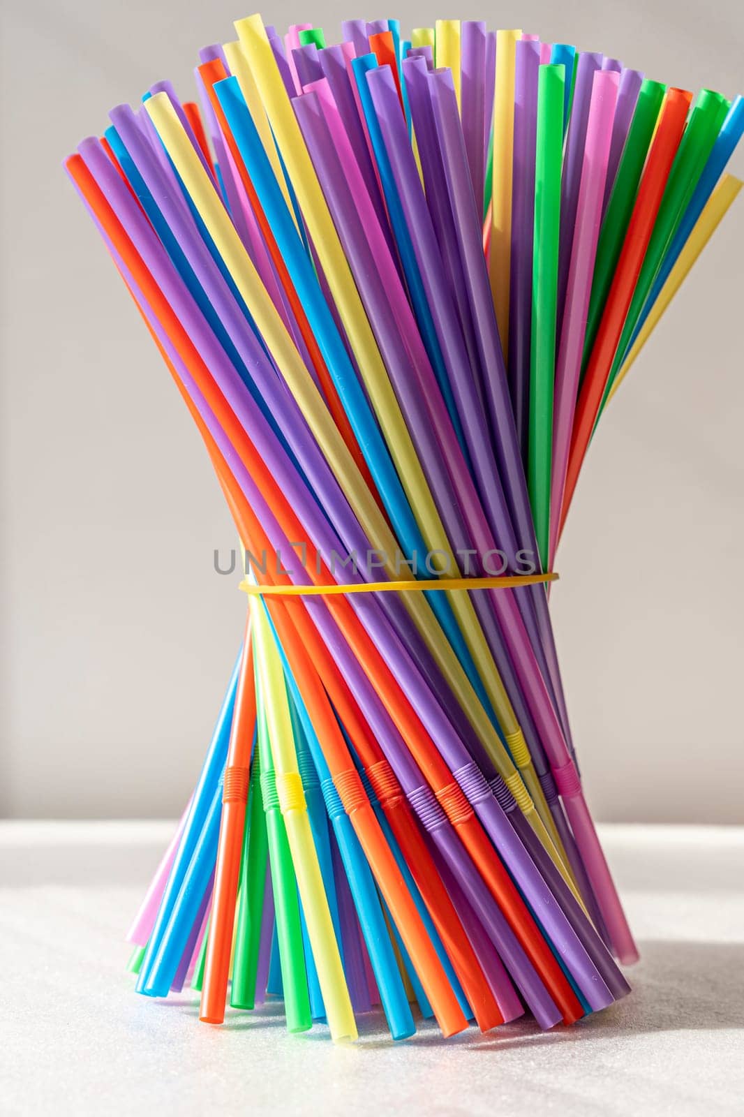bright multicolored cocktail tubes are clamped with an elastic band by audiznam2609