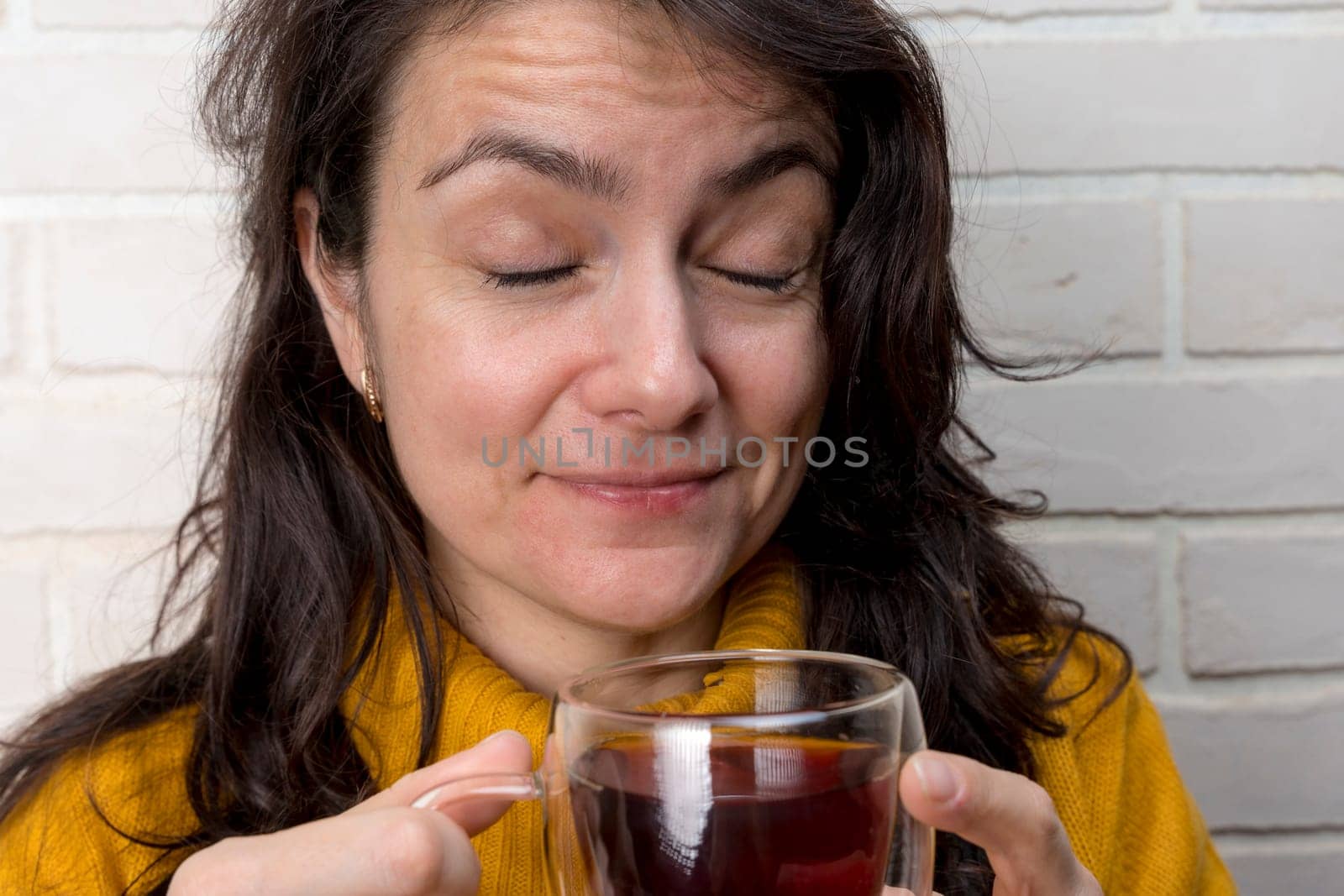 woman drinks tea and closes her eyes with pleasure by audiznam2609