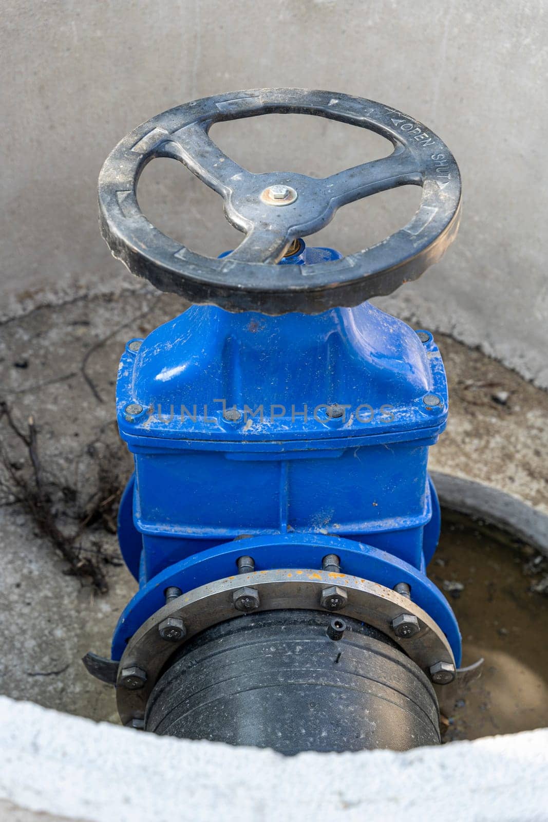 A valve or valve in a valve concrete well of an underground sewer. Construction of pipeline networks. Laying of the pipeline of the water supply system in the city. Water supply, repair of worn-out pipelines.