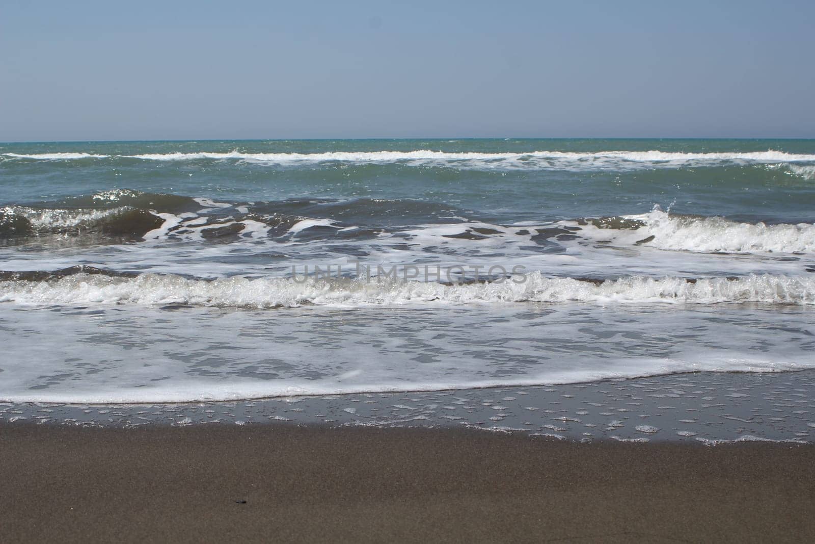 Front view of beach waves at the sea shore. Summer