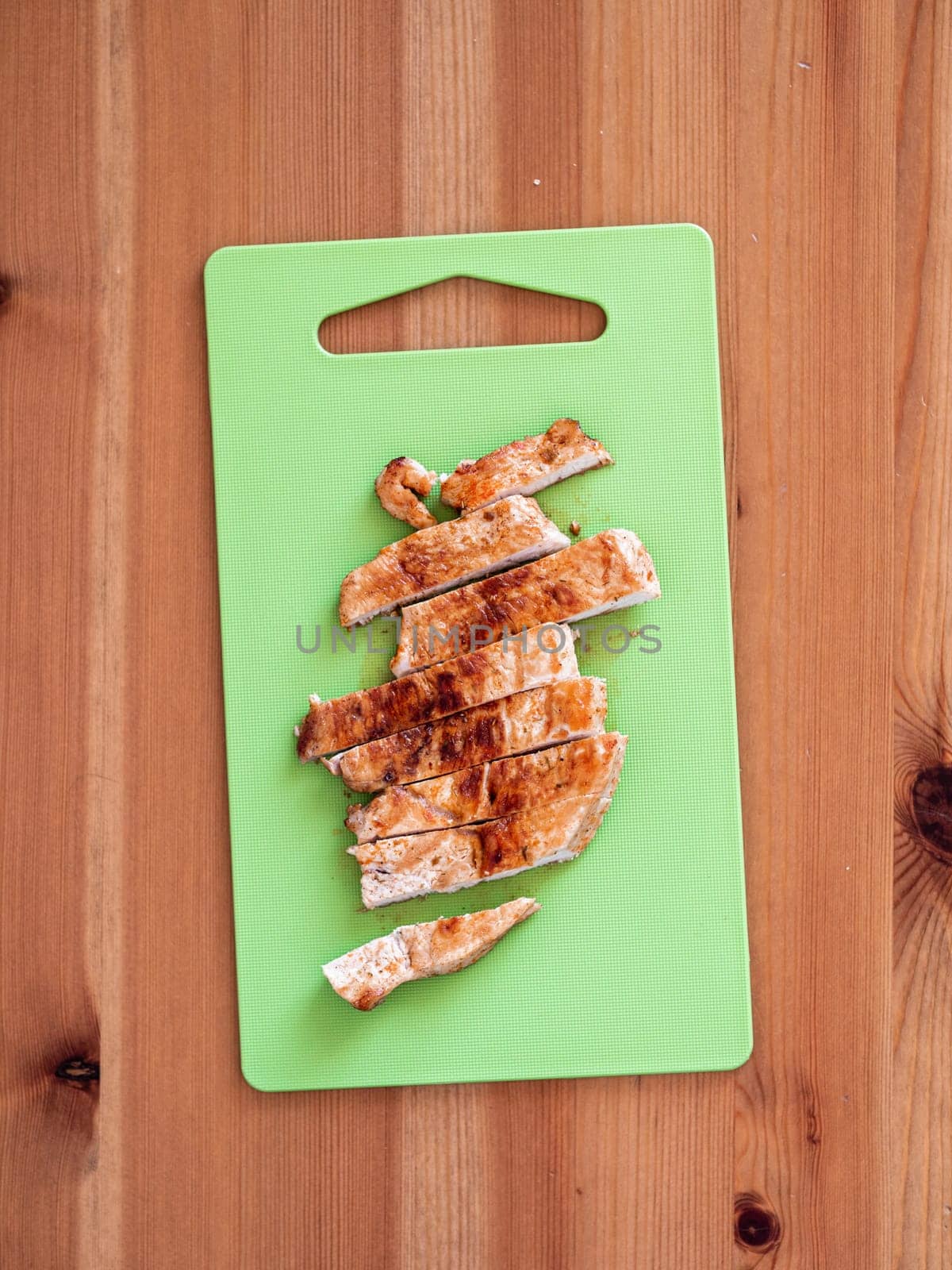 grilled turkey meat steak sliced on cutting board by fascinadora