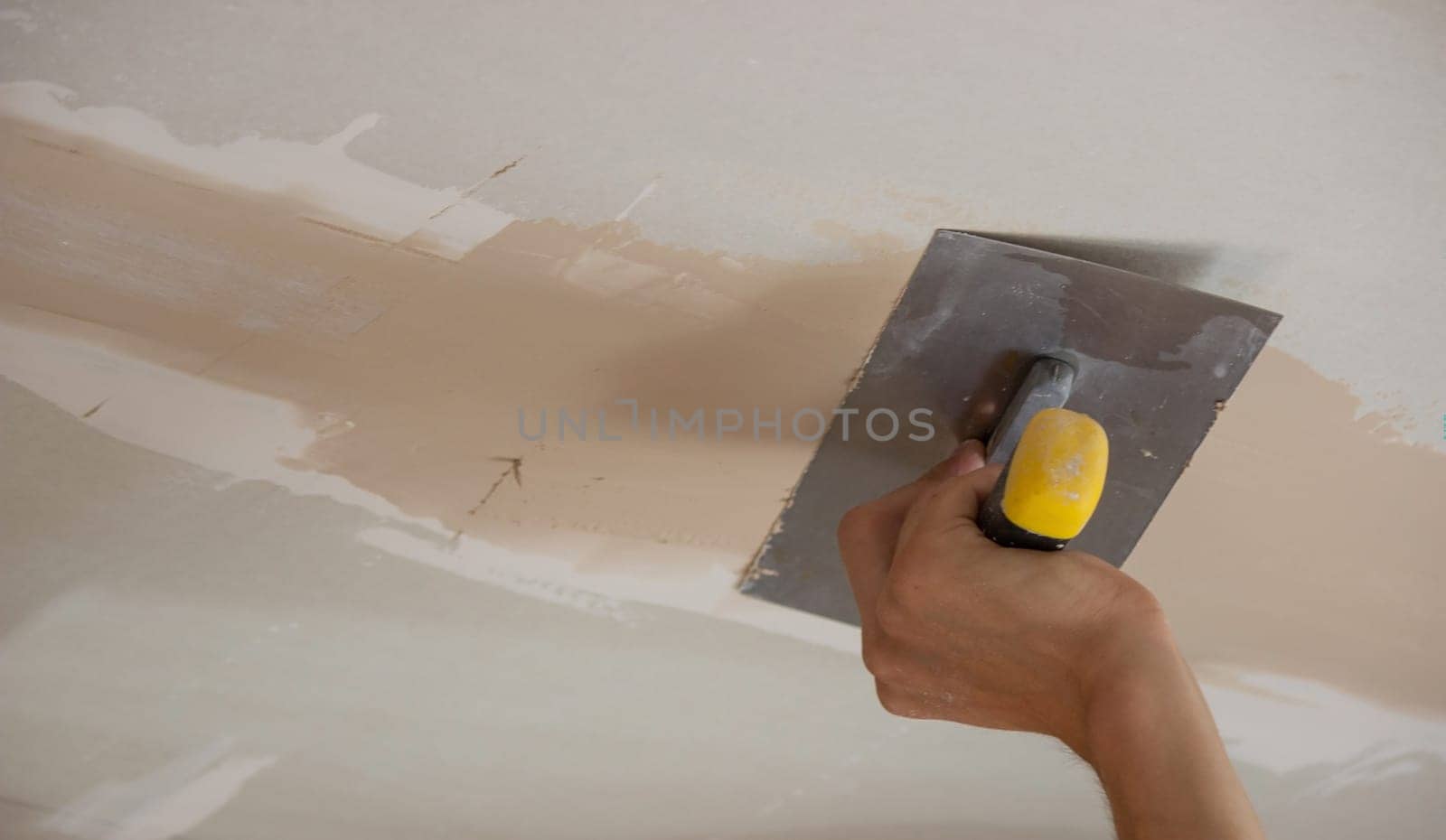 the master plasters the walls and ceiling. Selective focus