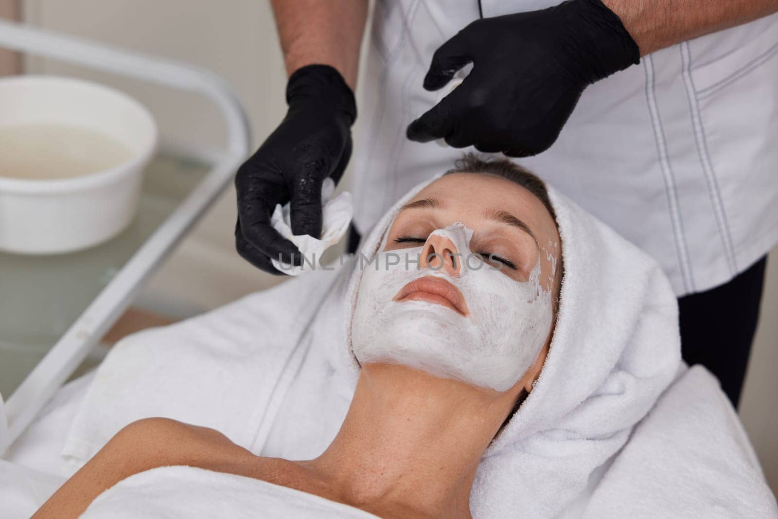 close-up of beautician cleanses skin of woman . Perfect cleaning, skincare face.