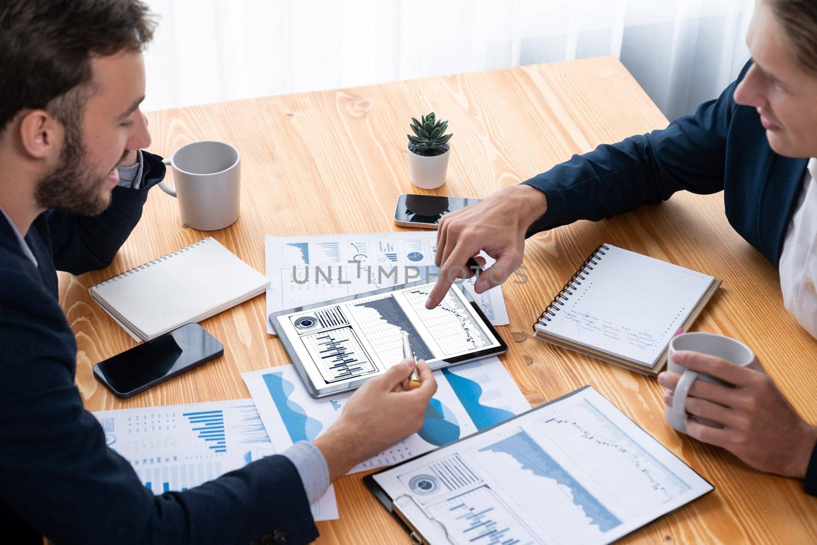 Busy analyst team in office analyzing financial data analysis for marketing strategy in workspace using BI dashboard with graph and chart on tablet screen to improve business performance. Entity