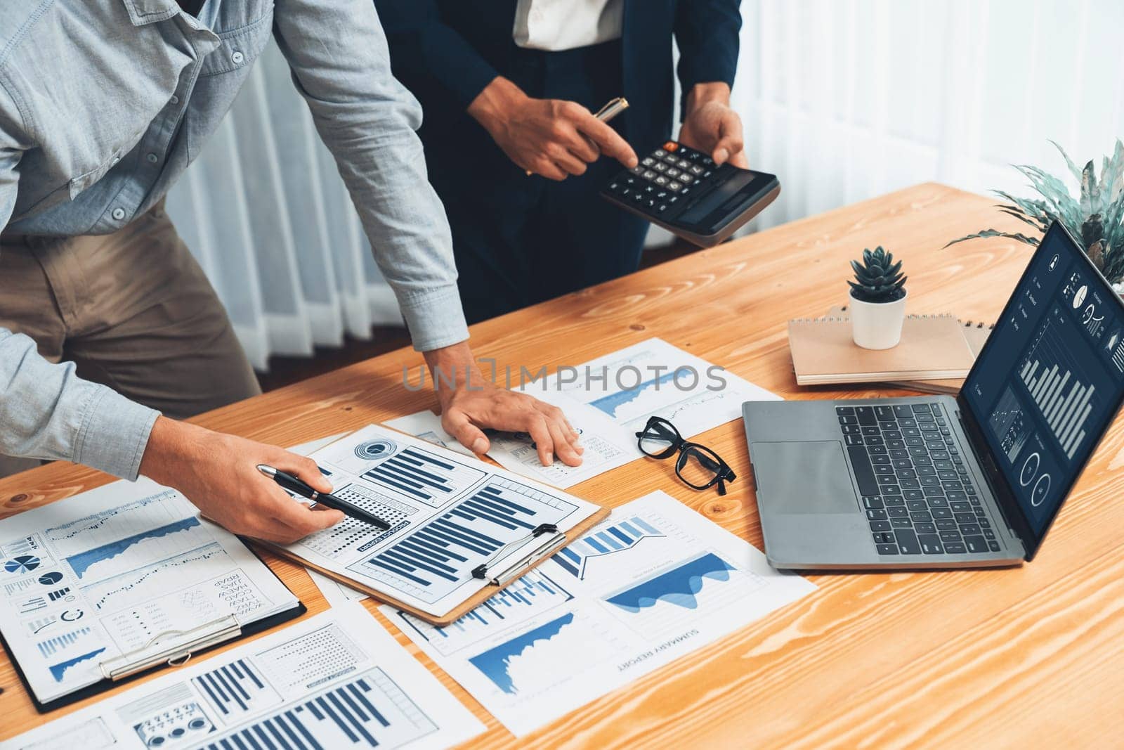 Busy analyst team in office analyzing financial data analysis for marketing strategy in workspace using BI dashboard with graph and chart on laptop screen to improve business performance. Entity