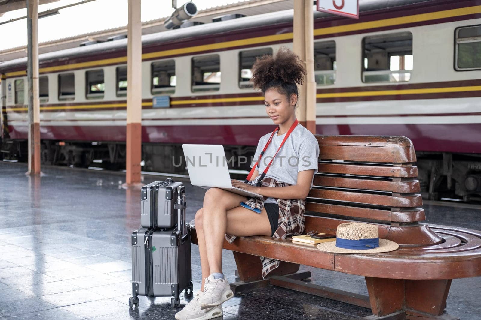 Young woman girl female sitting use computer laptop and travel bag suit case on the floor at station. High quality photoYoung woman girl female sitting use computer laptop and travel bag suit case on the floor at station