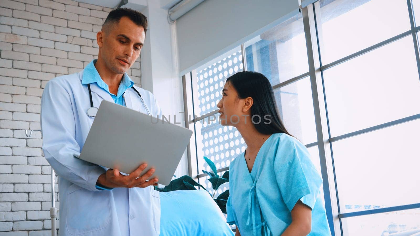 Doctor in professional uniform examining patient at hospital or medical clinic. Health care , medical and doctor staff service concept. Jivy