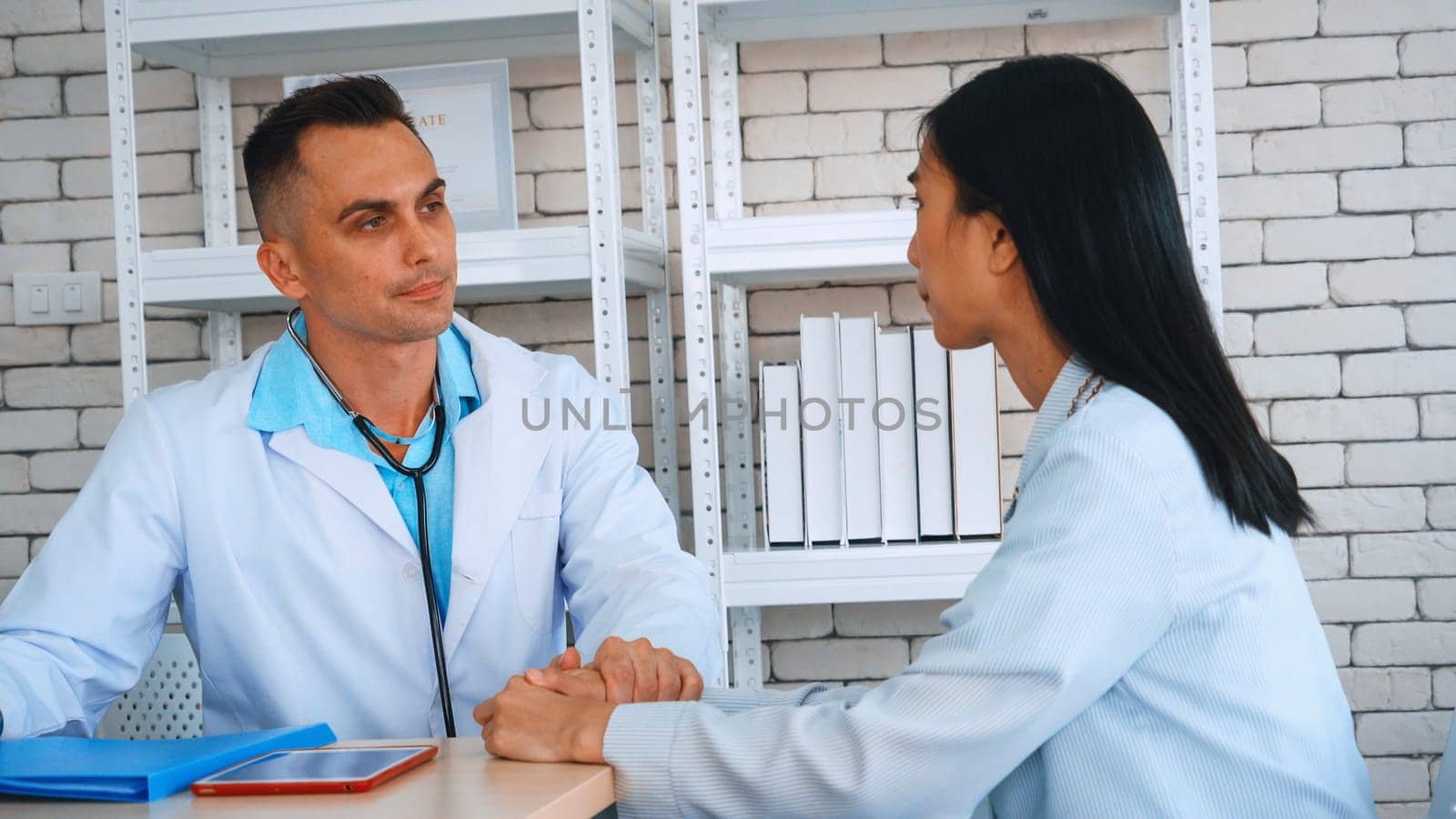 Doctor in professional uniform examining patient at hospital or medical clinic. Health care , medical and doctor staff service concept. Jivy