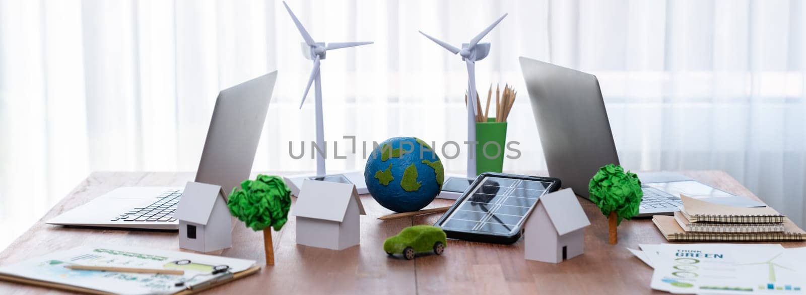 Environment friendly company office table with various eco mockup for environmental conservative concept. Green business with zero net reducing impact on global warming. Trailblazing