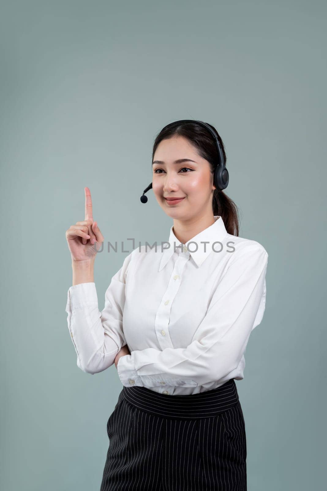 Asian operator wearing formal suit and headset with pointing finger Enthusiastic by biancoblue