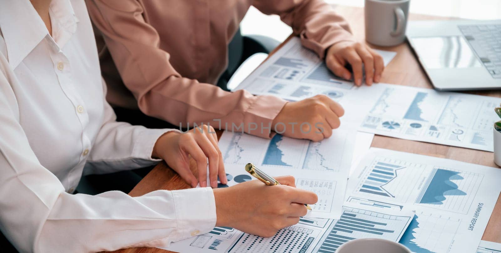 Closeup analyst team colleagues discuss financial data on digital dashboard, analyzing charts and graph with supportive teamwork. Professional office use BI to plan marketing business. Enthusiastic