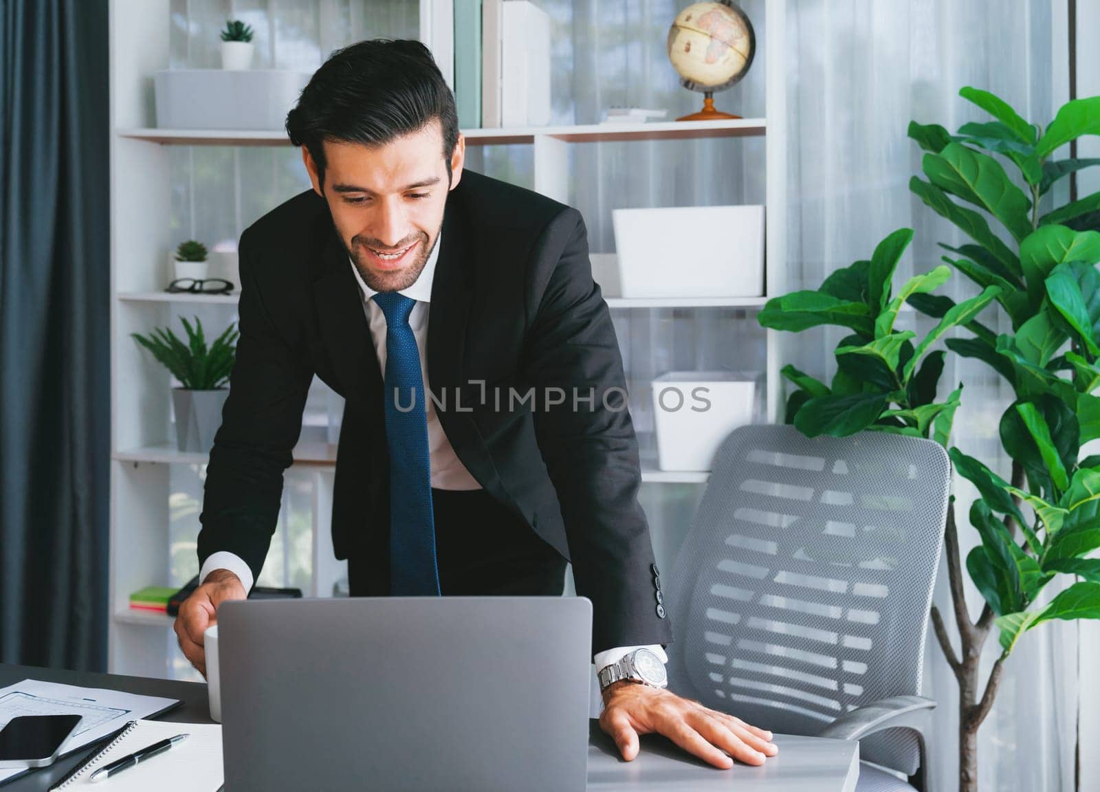 Modern professional businessman at modern office desk. fervent by biancoblue