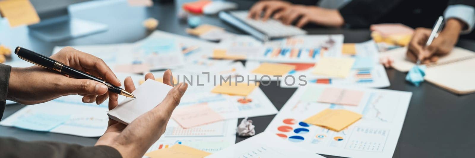 Analyst team use sticky note for financial insight with business Fintech papers for data analysis dashboard. Creative and analytic teamwork idea brainstorming for strategic business marketing. Prodigy