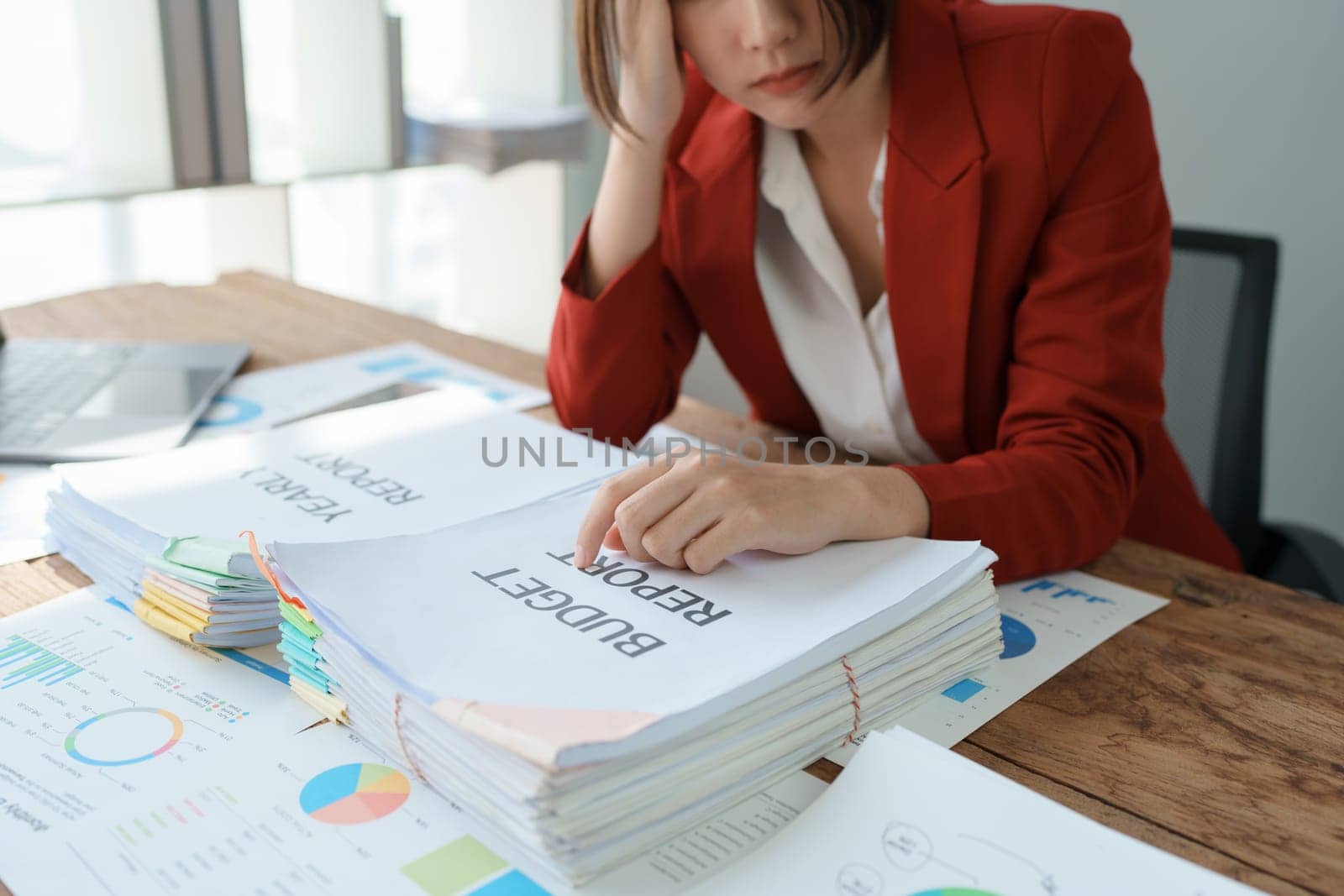 Portrait of business owner, woman using computer and financial statements Anxious expression on expanding the market to increase the ability to invest in business.