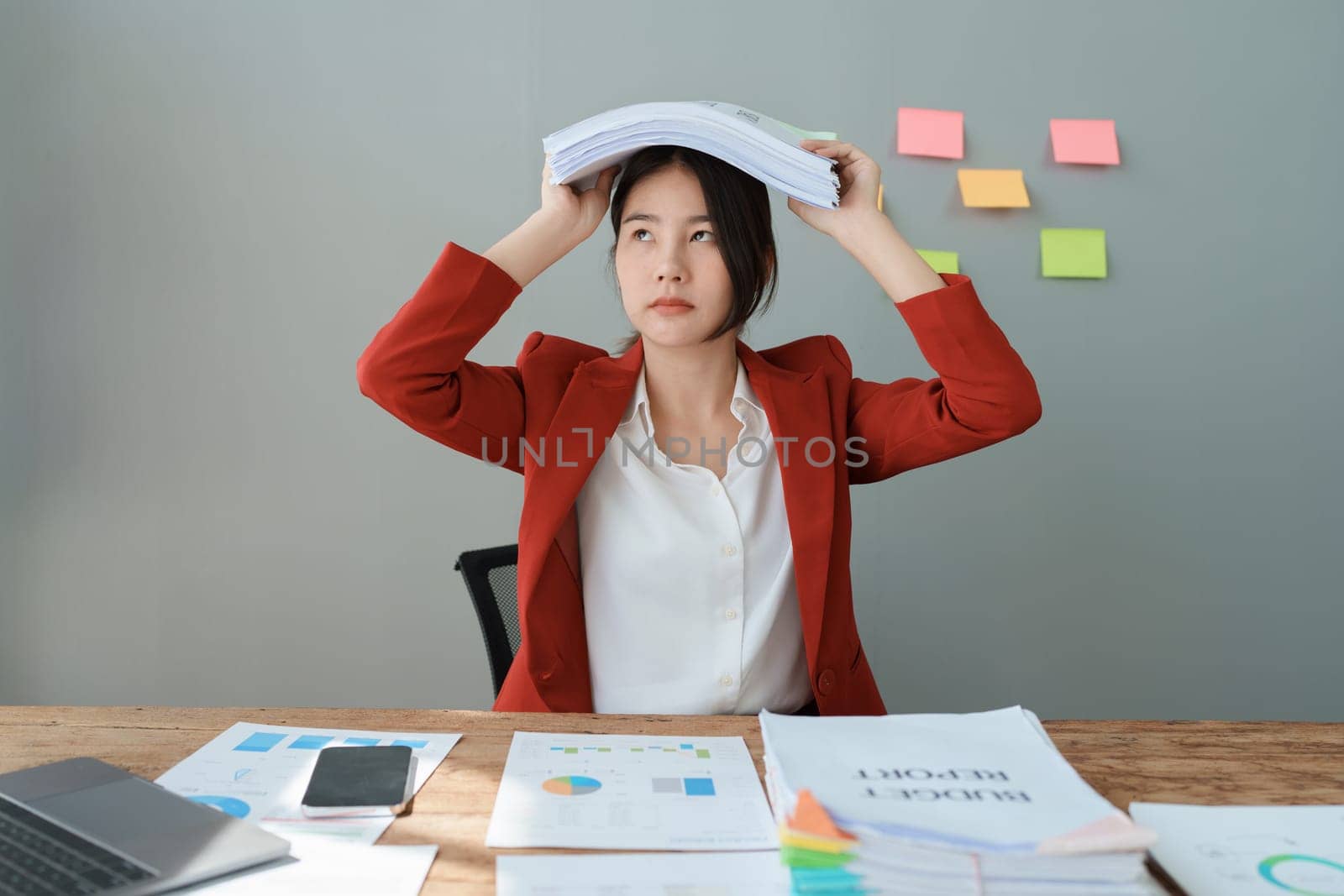 Portrait of business owner, woman using computer and financial statements Anxious expression on expanding the market to increase the ability to invest in business.