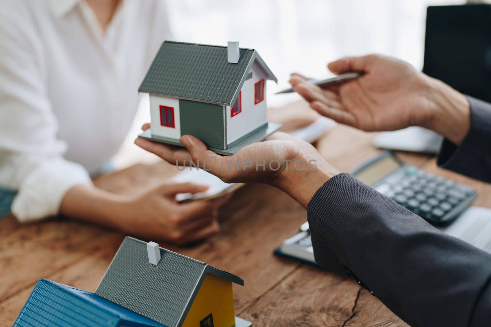 Real estate company to buy houses and land are delivering keys and houses to customers after agreeing to make a home purchase agreement and make a loan agreement. by Manastrong