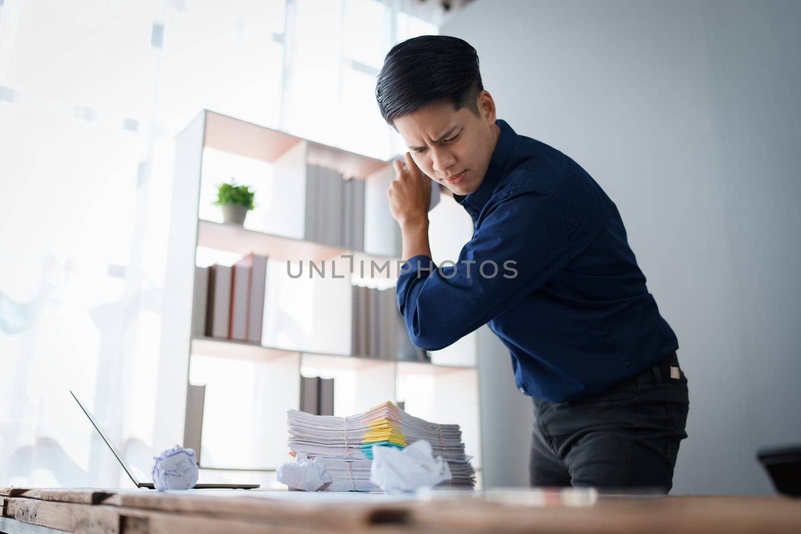 Portrait of business owner, man using computer and financial statements Anxious expression on expanding the market to increase the ability to invest in business