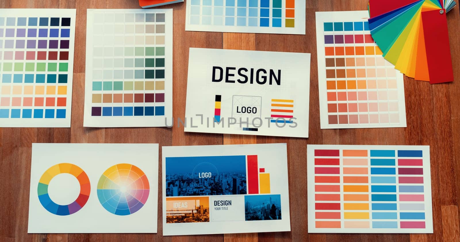 Panorama shot of various color palette idea papers arranged neatly on workspace table for graphic design concept. Color swatches and selection for unique digital art design. Scrutinize