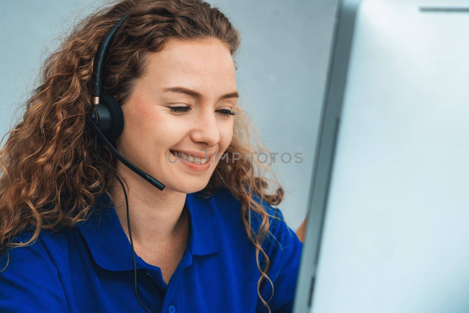 Business people wearing headset working in office to support remote customer or colleague. Call center, telemarketing, customer support agent provide service on telephone video conference call. Jivy