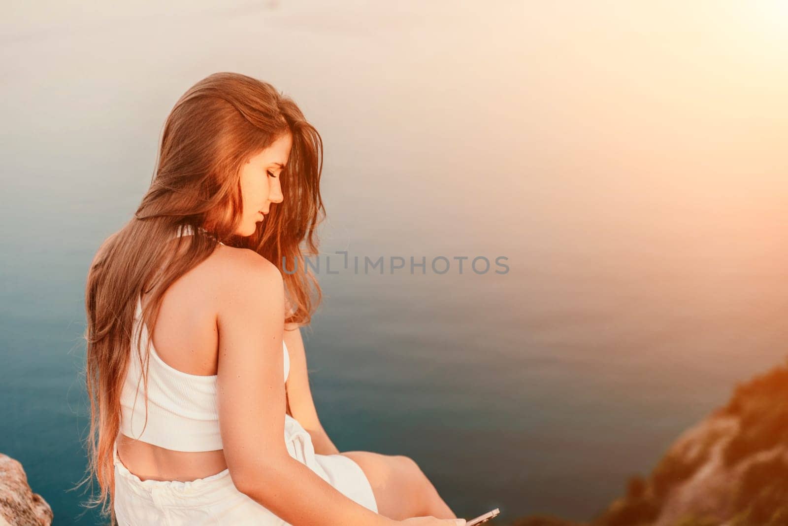 woman sea. portrait in white shorts and T-shirt with long hair, standing against the sea, showcasing her joyful and contented mood. by Matiunina
