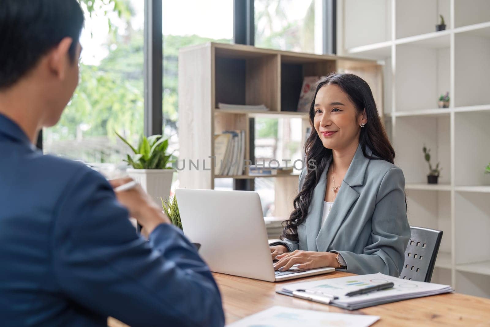 Two business at the office discuss about business strategy of new investments. Successful business people sitting together at a table.