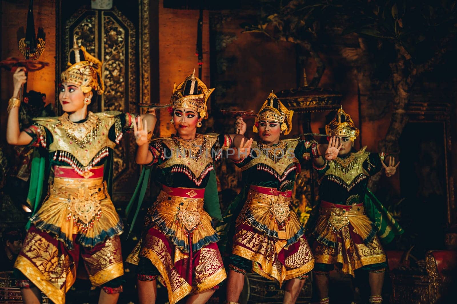 UBUD, BALI, INDONESIA - FEBRUARY 10, 2023: Traditional dance Legong and Barong in Ubud Palace, Balinese dance show with colorful dressed artists. Traditional balinese religious ritual performance