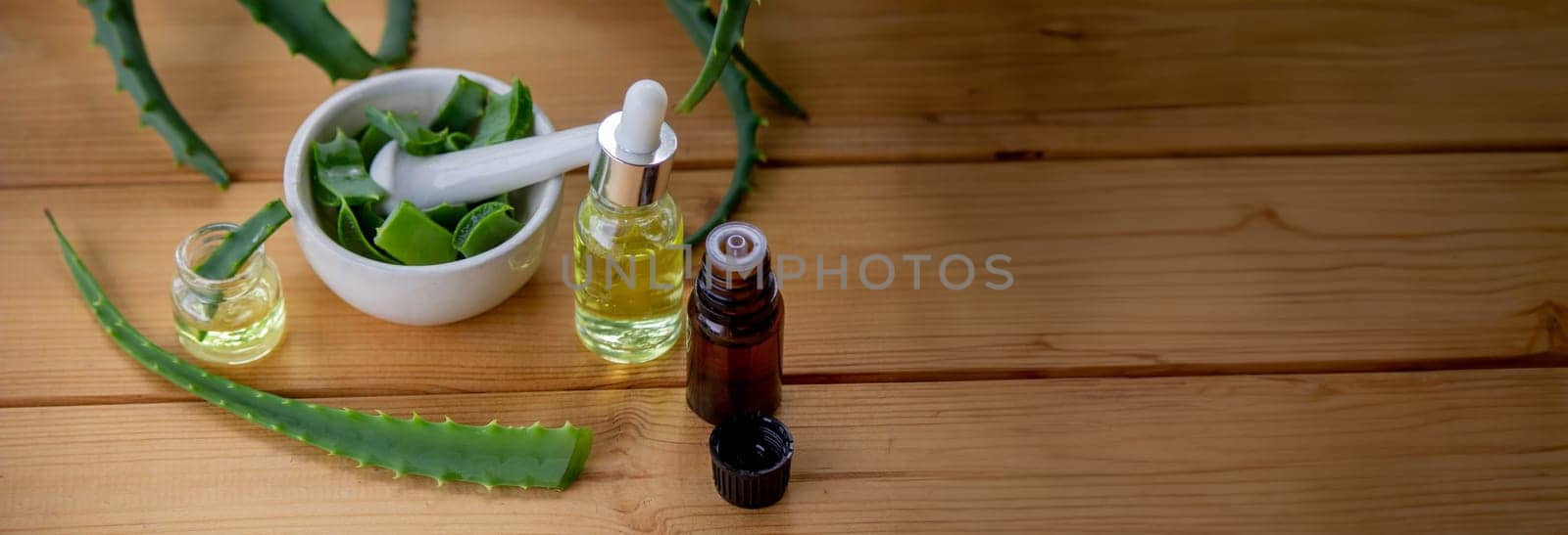 aloe vera essential oil on a wooden background, juice. Selective focus