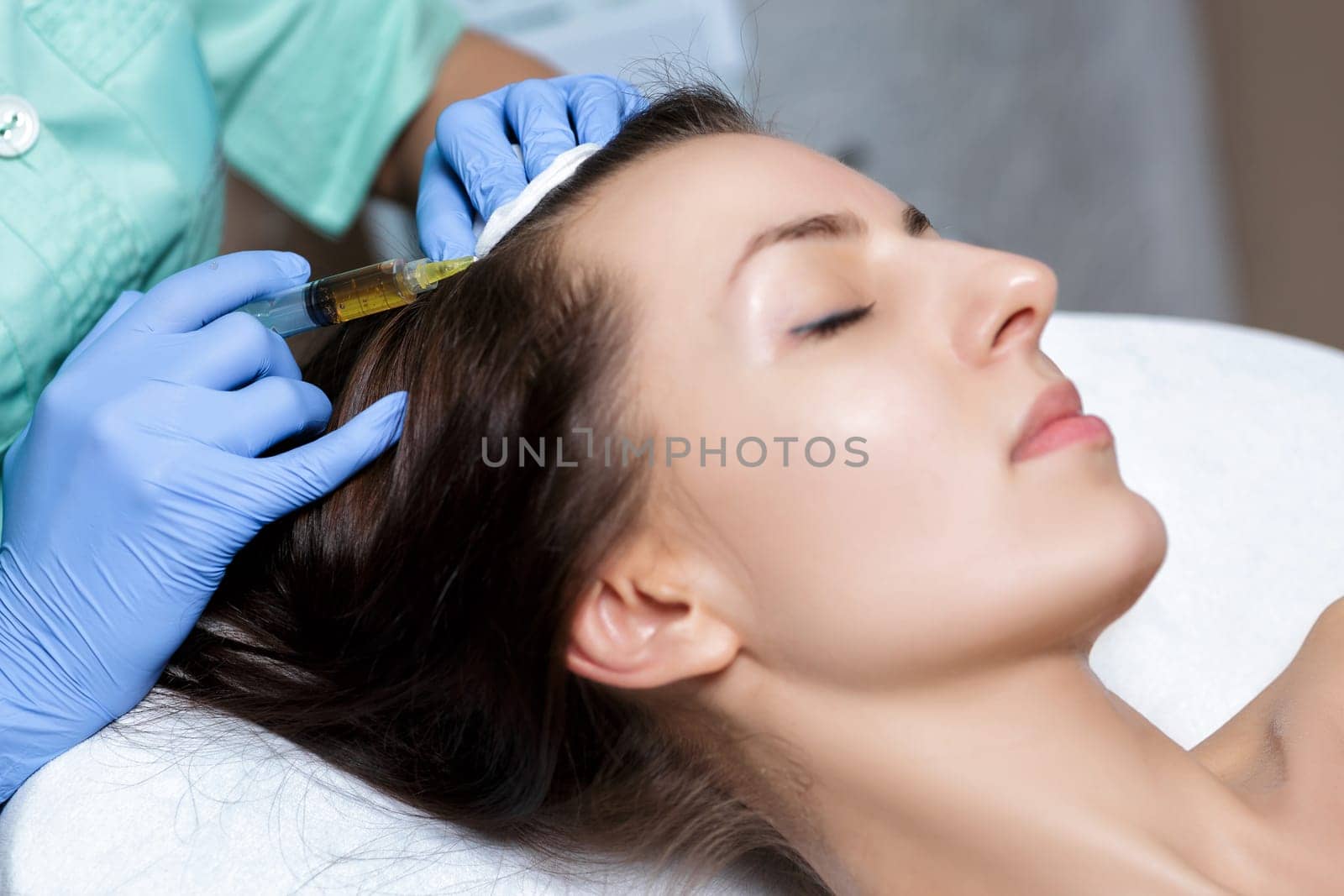 Needle mesotherapy. Cosmetic been injected in woman's head. Thrust to strengthen the hair and their growth