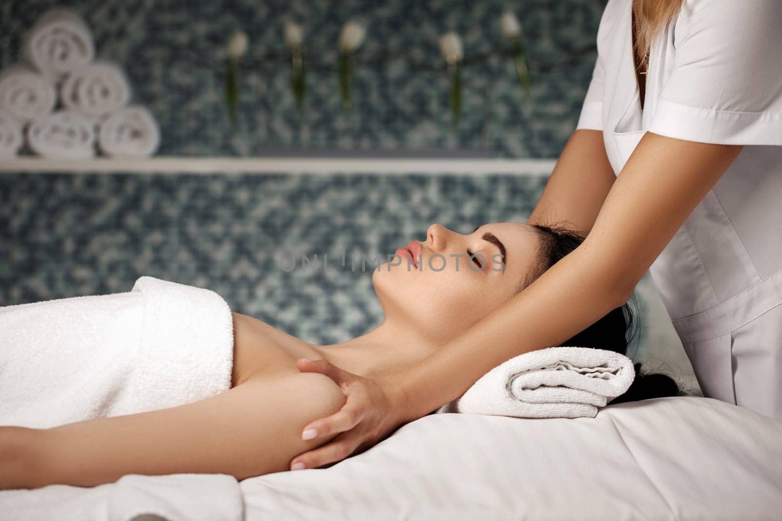 anti-aging facial massage. Woman receiving massage from masseur at Spa salon.