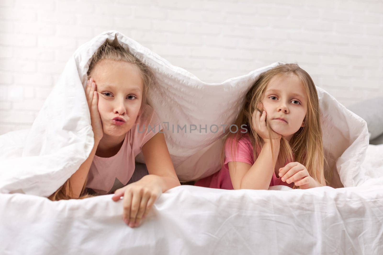 happy smiling morning kids in bed. children dabble in bed