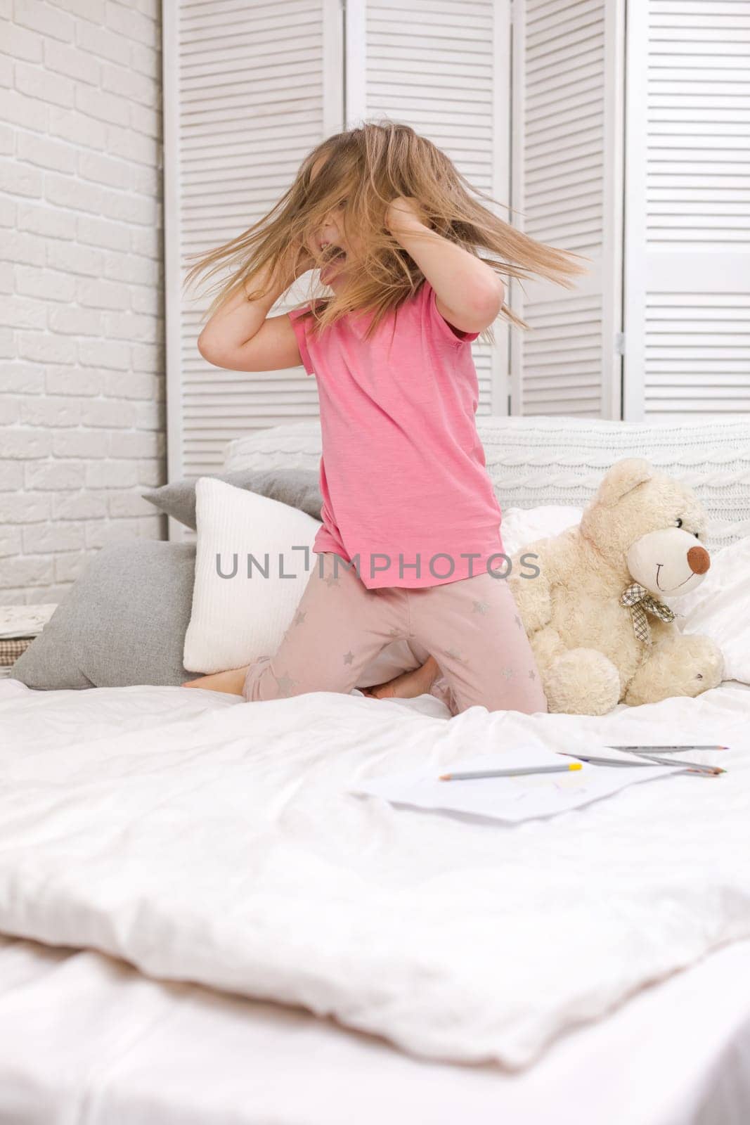 cute little child girl fooling around in bed