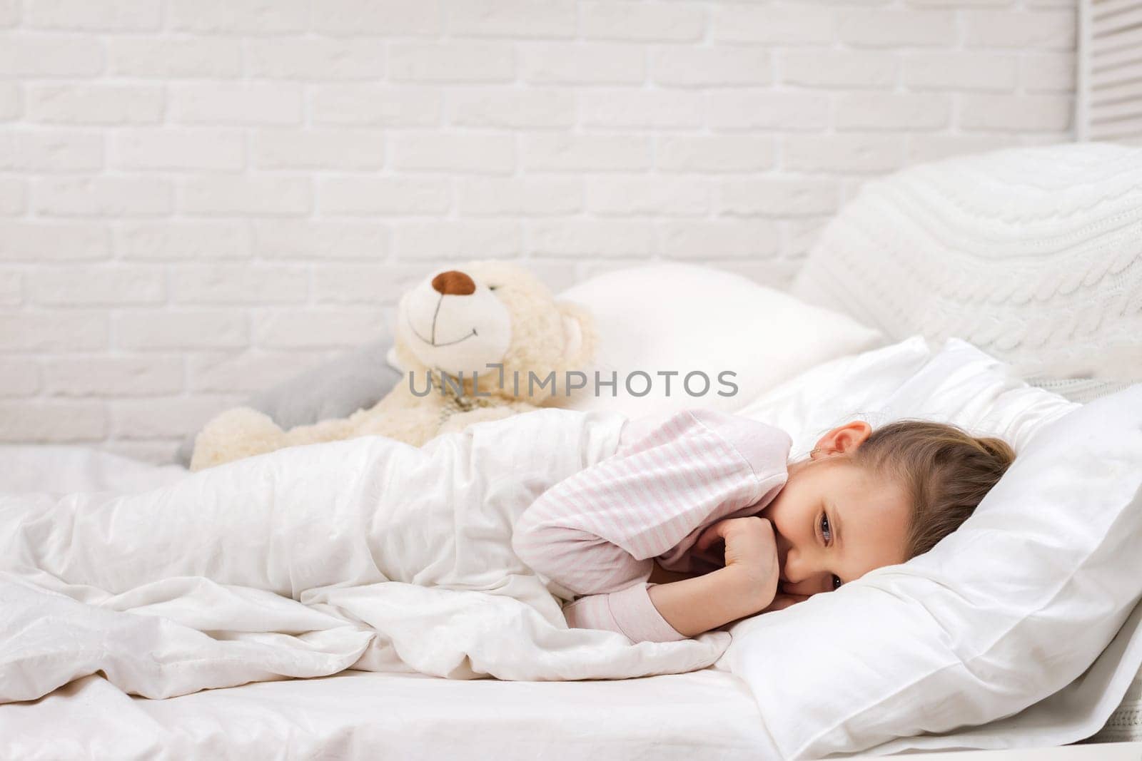 smiling little child girl sleeping in her bed