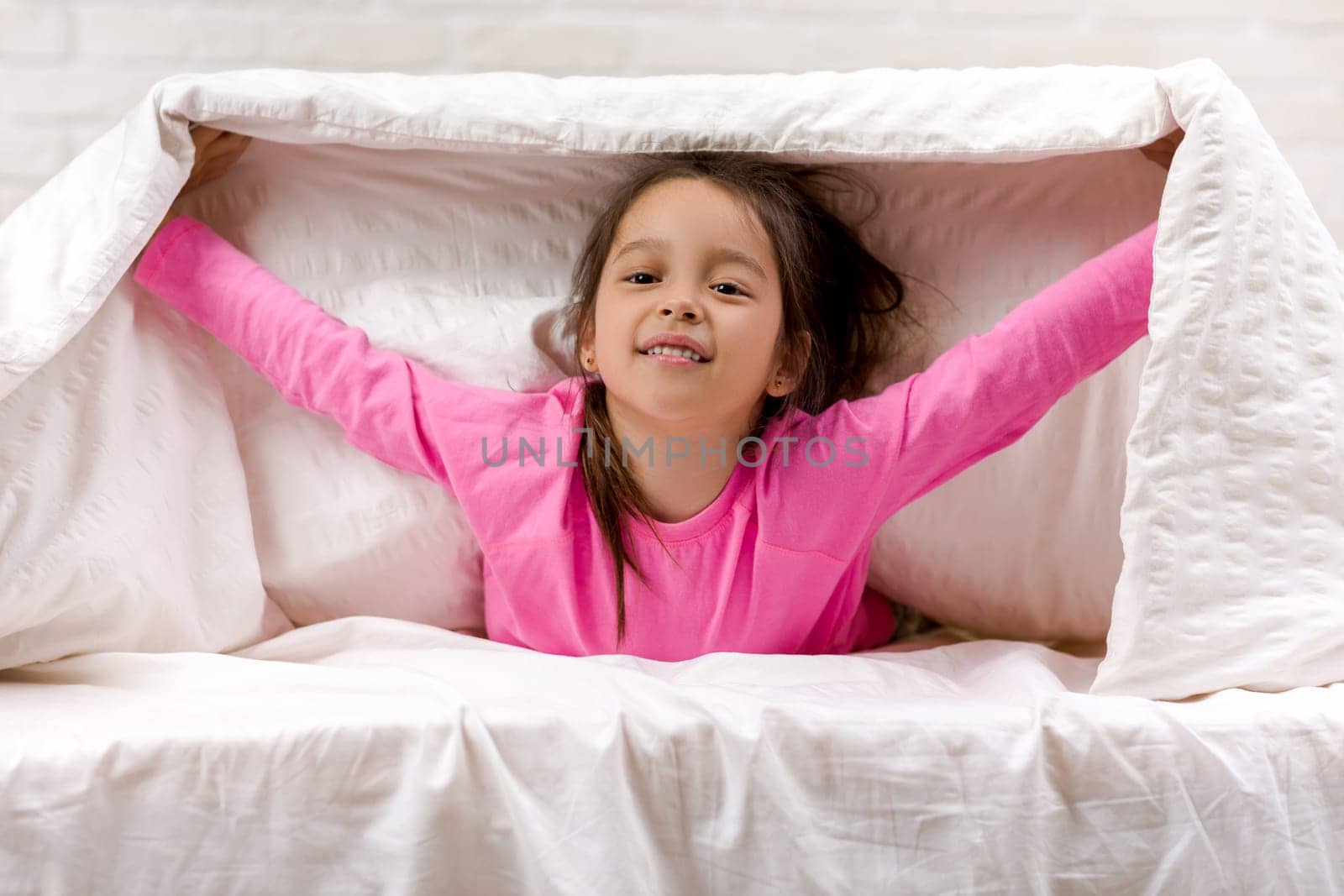 happy morning baby in bed. child dabbles in bed