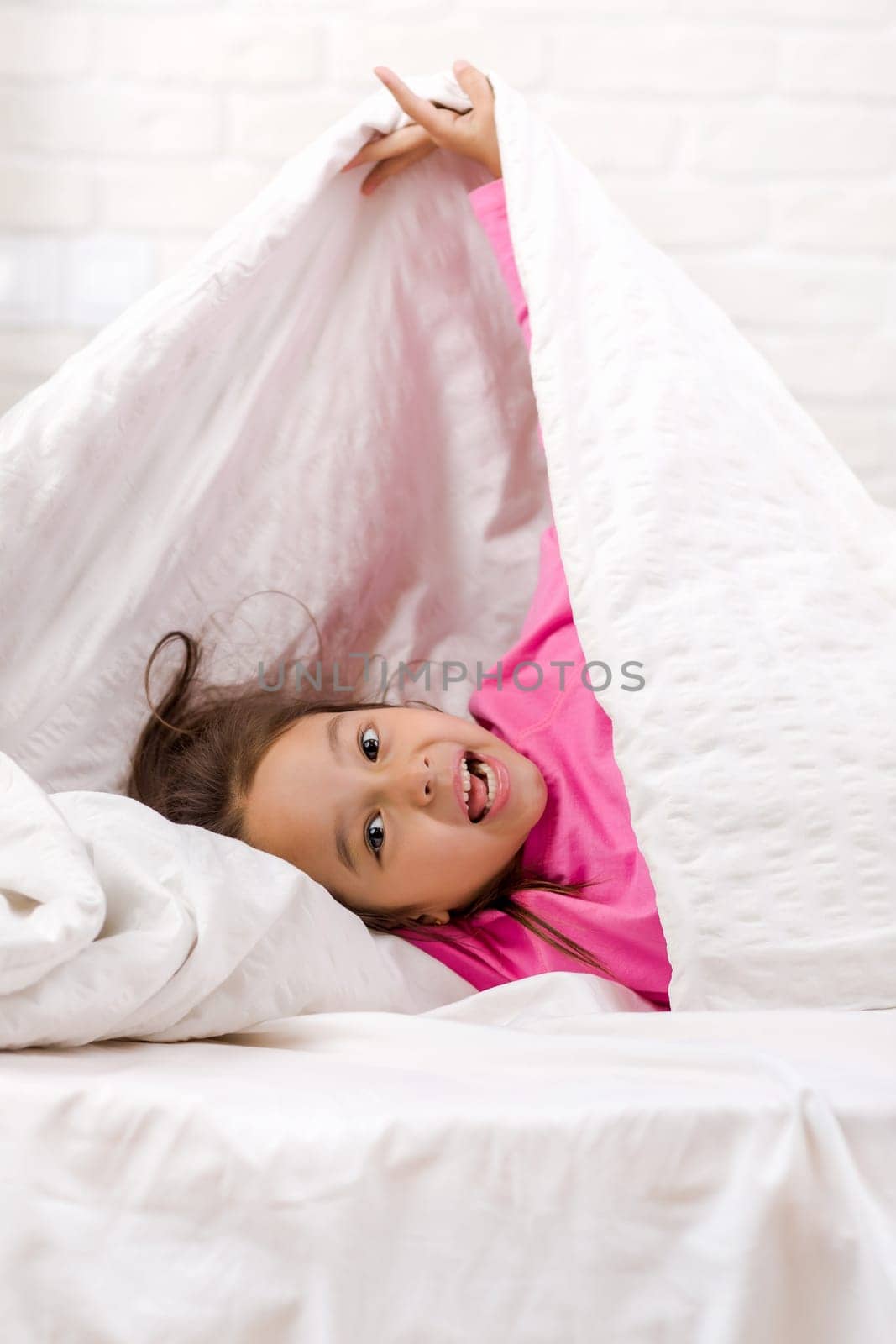 happy morning baby in bed. child dabbles in bed