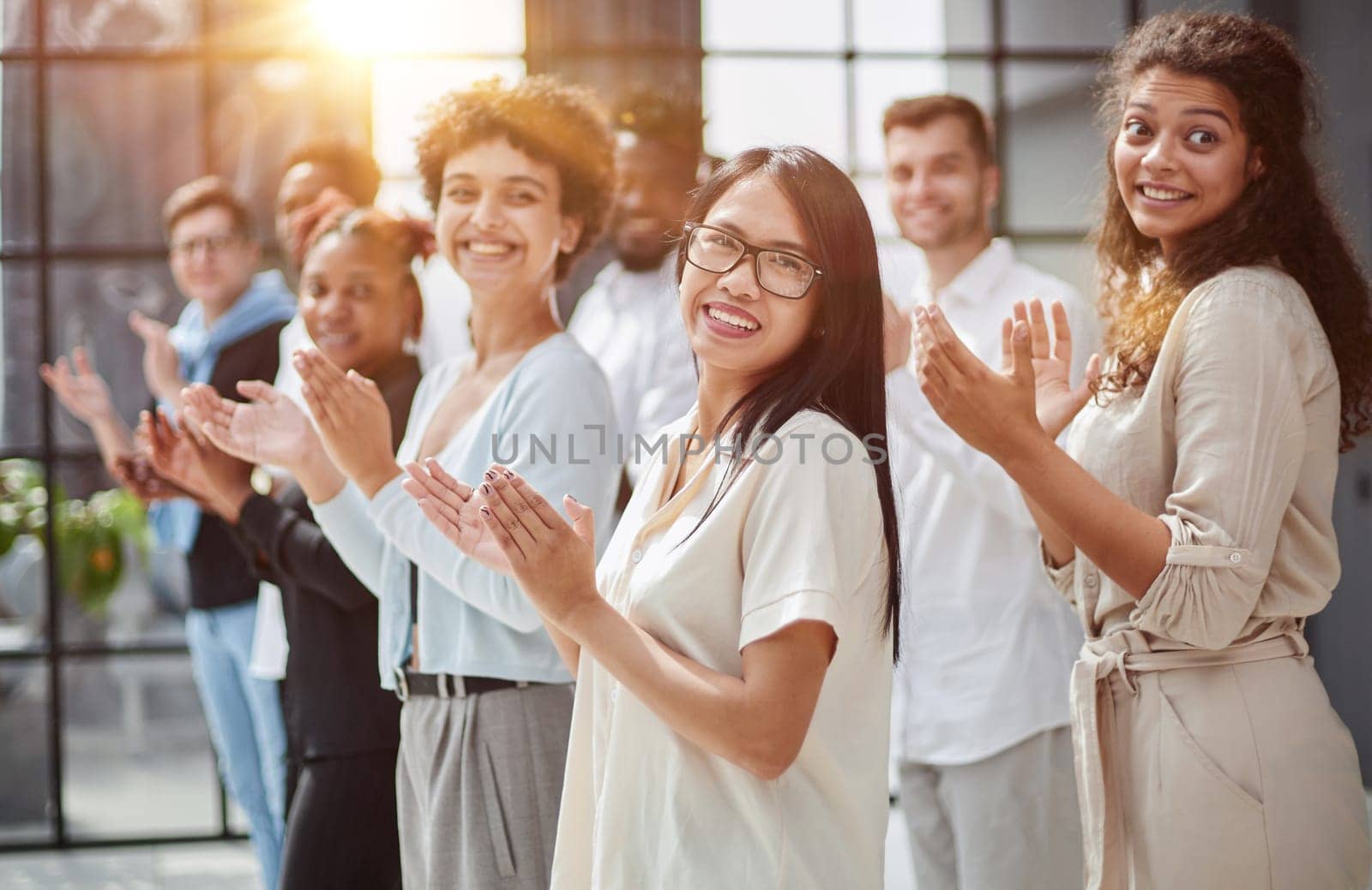 arge international group of happy people applauding together