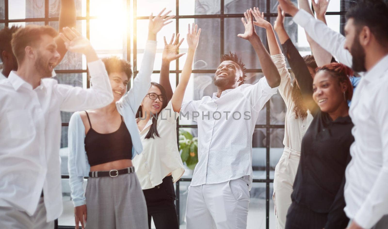 Raised up hands and arms of large group in seminar class room to agree with speaker at conference seminar meeting room