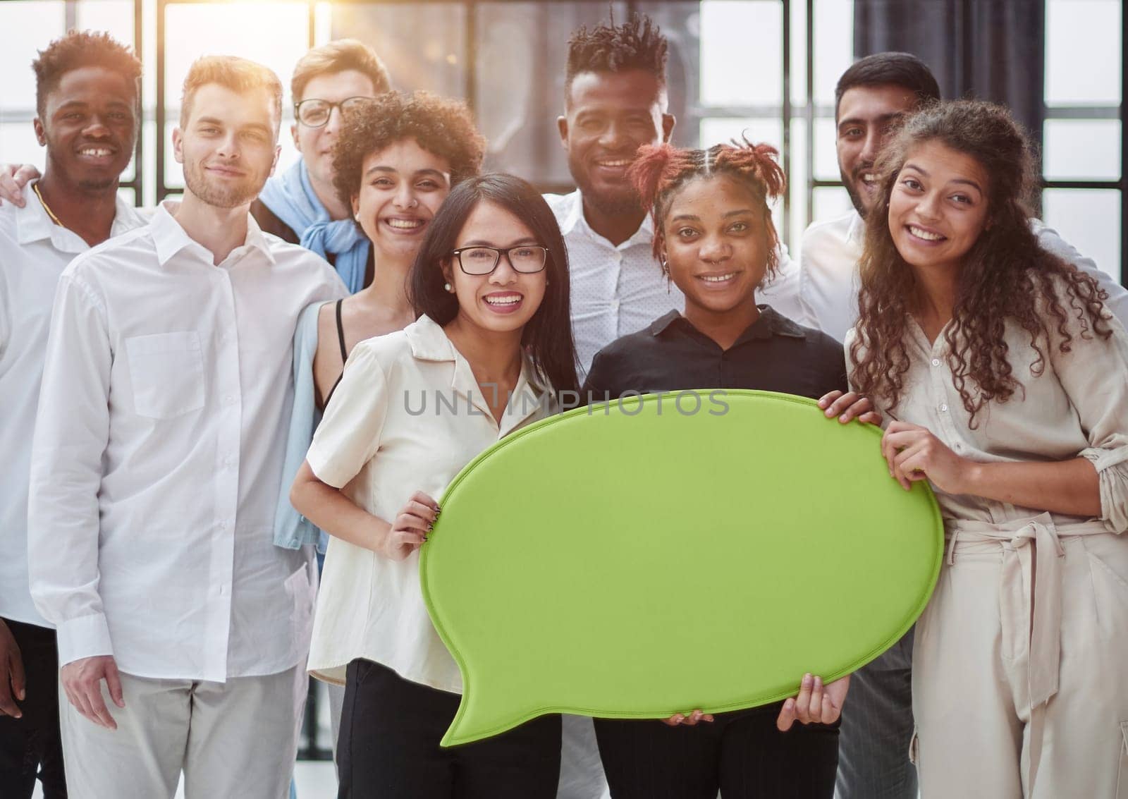 young group of people holding speech bubbles in modern office by Prosto