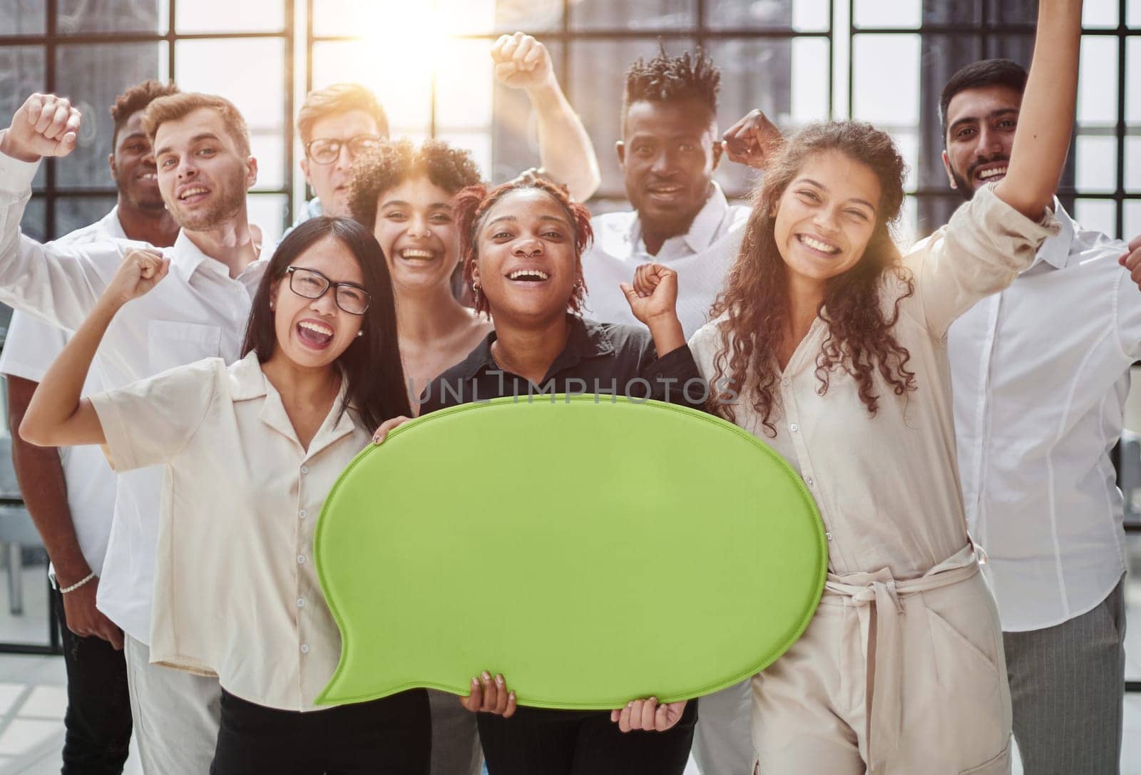 young group of people holding speech bubbles in modern office by Prosto