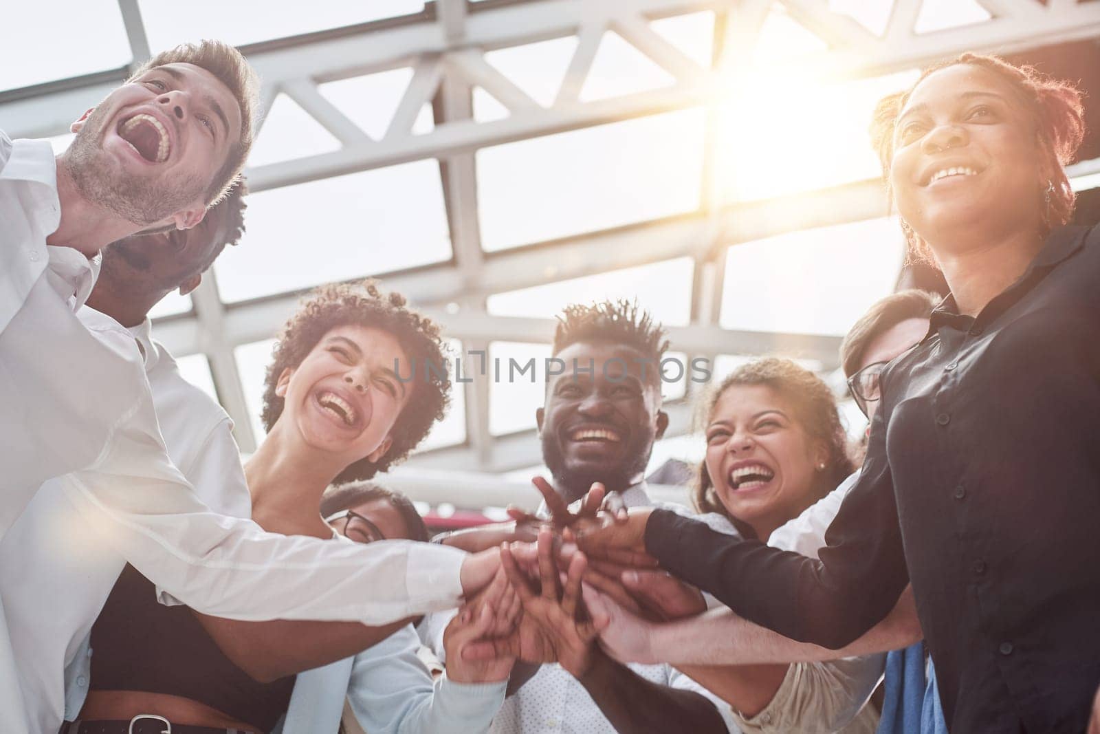 A group of international business people are standing in a modern office